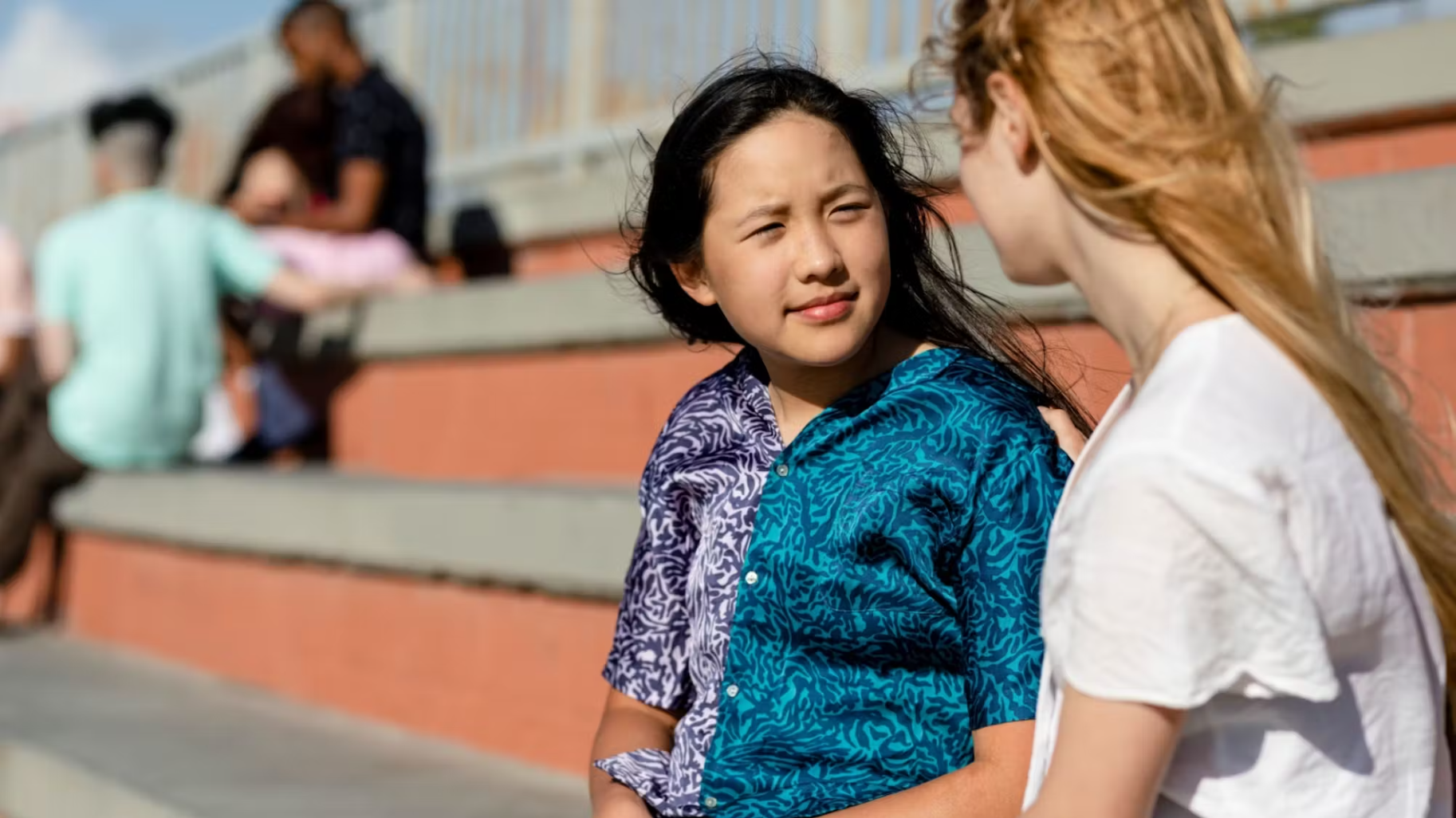 an asian teen girl talking with another girl